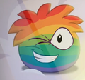 The Rainbow Puffle winking, as seen in Puffle Party (Gotta Have a Wingman).