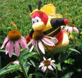 A bumblebee penguin flying toward flowers.