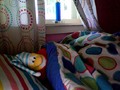 A penguin in pajamas, getting ready for bed.