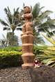Rockhopper standing near a statue.