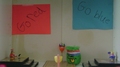 A green puffle cheering for the red team or blue team.
