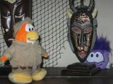 A penguin playing Hide and Seek with a puffle.