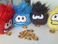 Four puffles enjoying some Puffle O's.