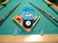 A blue puffle on a pool table.