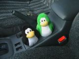 Two penguins in a car.
