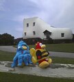 Squidzoid penguin and Bee penguin sitting on a fence.