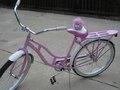 A pink puffle on a bike.