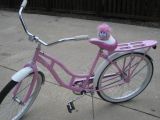 A pink puffle on a bike.