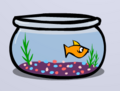 A goldfish in a bowl located in a penguin's Igloo.